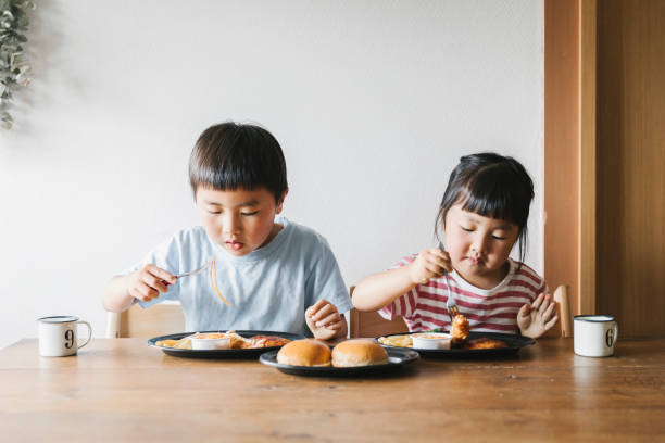 istock Siblings eating Takeaway meals at home 1255194660