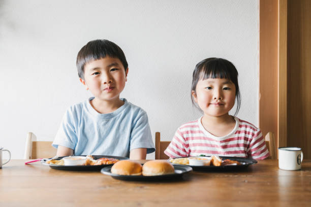 istock Siblings eating Takeaway meals at home 1255194669