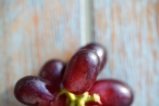 Fresh red grapes on wooden background