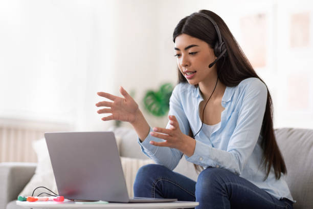 istock Online Tutoring. Young asian female tutor having video call with students 1255196470