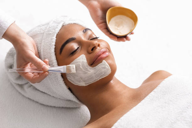 istock Top view of beauty therapist applying face mask 1255197727