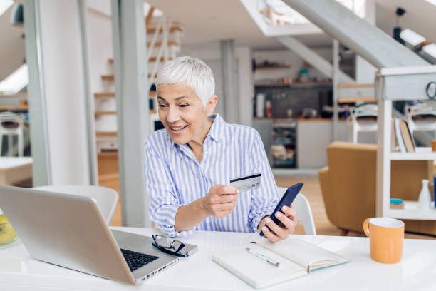 istock Senior businesswoman baking from her home office 1255199086