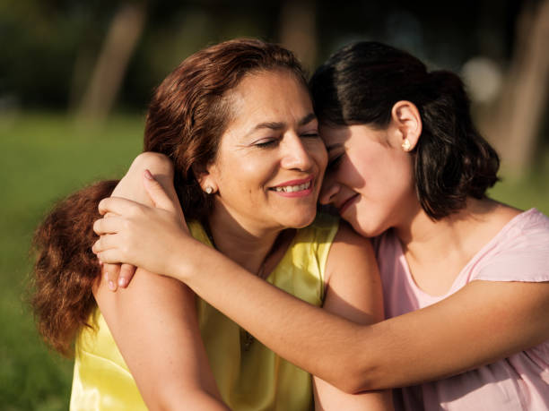 istock Young woman embracing mother outside 1255200295