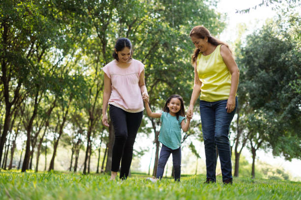 istock Three-generation family holding hands and walking 1255200346