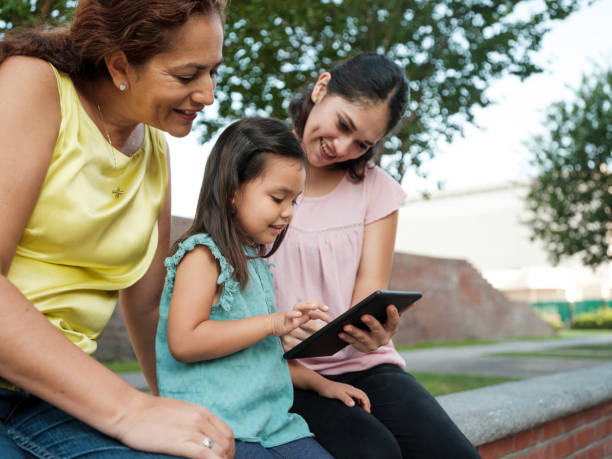 istock Three-generations female family using digital tablet outside 1255200349