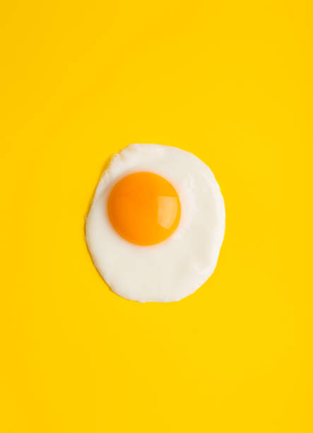 istock Close up fried egg at yellow background with free space 1255202089