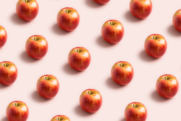 istock Apple minimal pattern at soft pink background. Concept of harvest raw food 1255202104