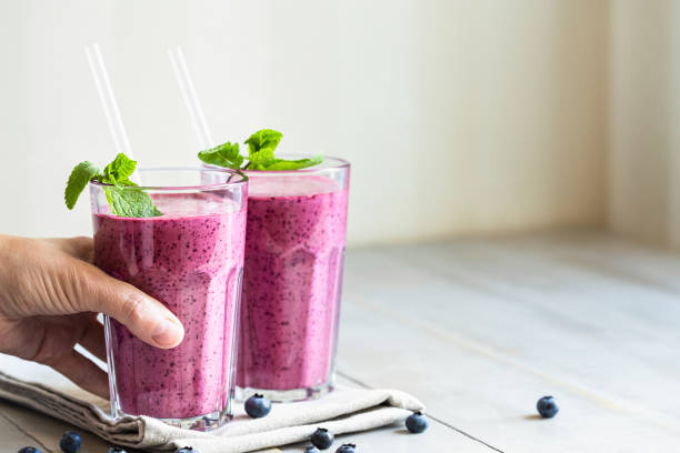 istock Two glasses of blueberry smoothie. 1255203073