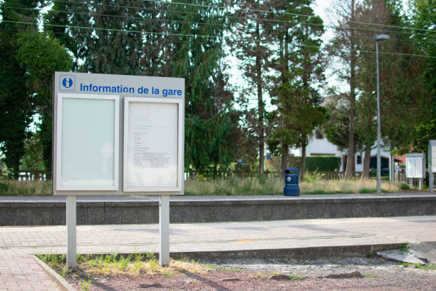 istock Waterloo,Belgium - July 25 2019: Information panel at the Waterloo train station on a sunny day with a blue garbage can in the background 1255207280