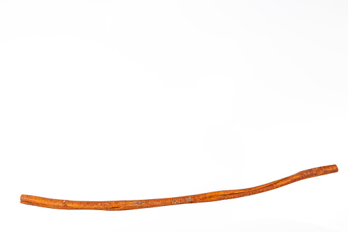 Image of a dried cinnamon bark strip (Cinnamomum verum) isolated on white background