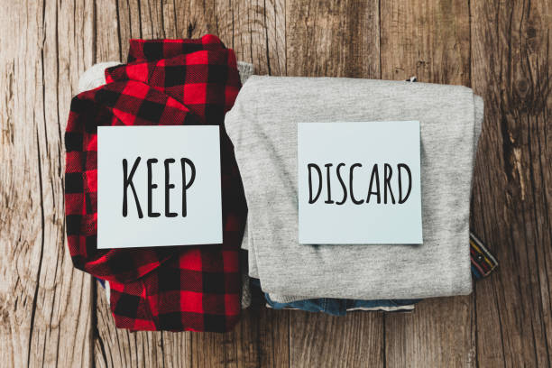 istock Stack of old clothes to discard (declutter) or keep. Recycle clothes, eco cotton 1255209864
