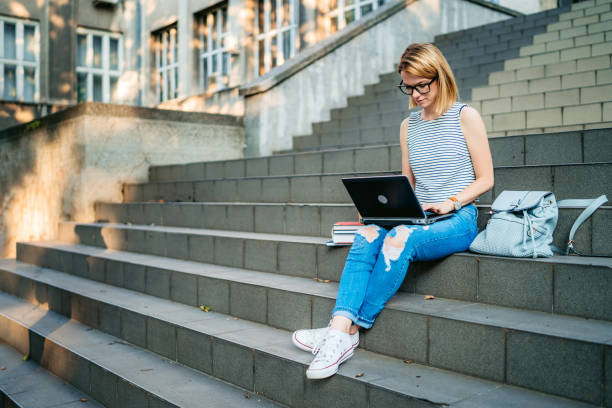 istock College woman studying on staircase 1255210667