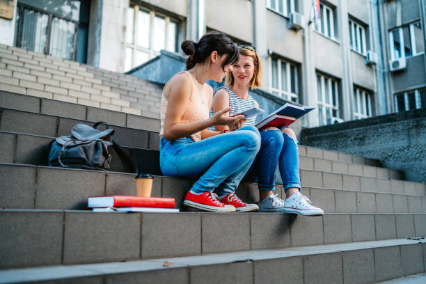 istock College women studying on staircase 1255210814