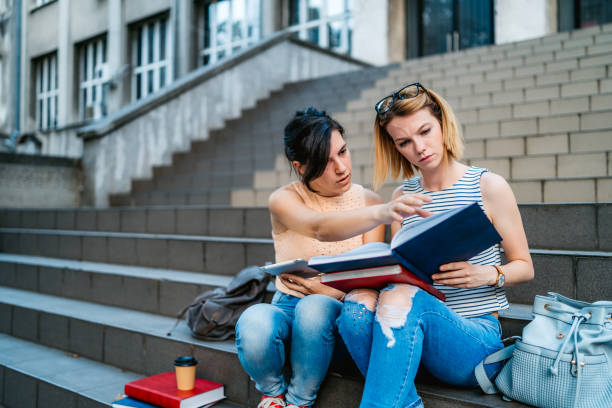 istock College women studying on staircase 1255210856