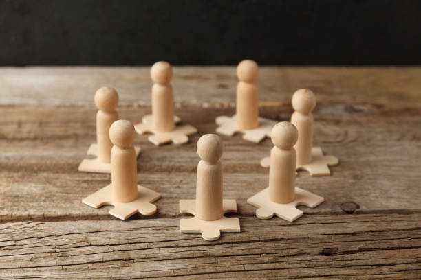 istock Wooden figures on puzzles. People analytics and optimization, team building. Group connection in business 1255211040