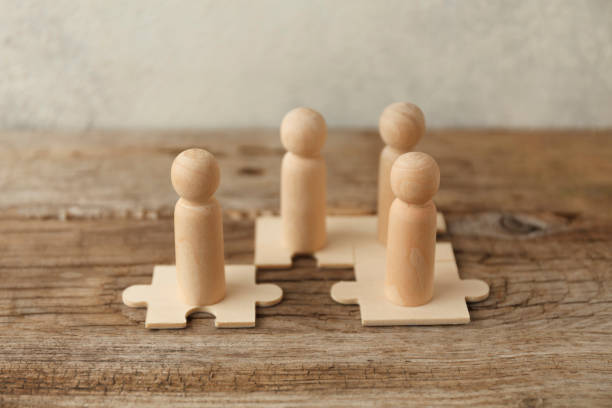 istock Wooden figures on puzzles. People analytics and optimization, team building. Group connection in business 1255211044