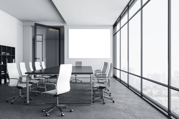 istock Modern meeting room with blank billboard on wall and city view. 1255214981