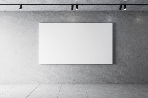 istock Minimalistic concrete interior with lamps on ceiling and poster on wall 1255215463
