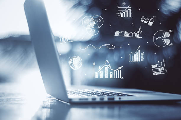 istock Laptop with stock charts and graphs 1255216511