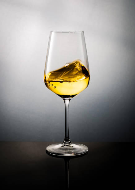istock Golden Color White Wine Swirled in a Glass 1255217464