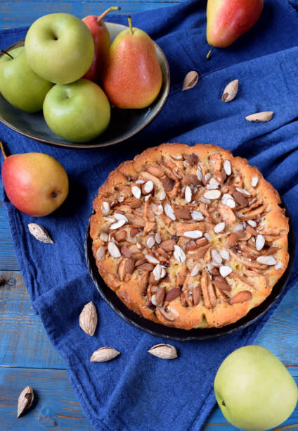 istock Pie with pears, apples and almonds on a black ceramic plate 1255220572