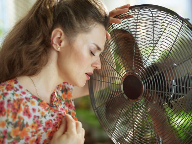istock unhappy young woman feeling summer heat 1255220816