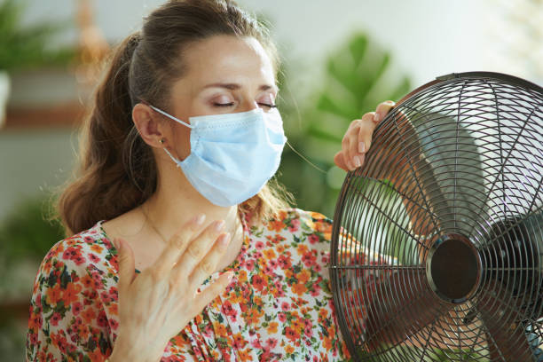 sad middle aged woman suffering from summer heat - garment emotional stress equipment household equipment imagens e fotografias de stock