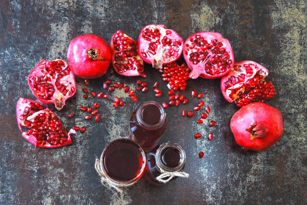 istock Freshly squeezed pomegranate juice in bottles and glasses. 1255222624