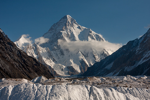 Alpinist climber team is proud of themselves while standing on snowy mountain crest on extreme harsh conditions.