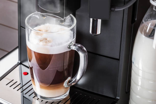 istock cup with hot cappuccino prepared in the coffee machine 1255226641