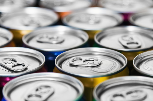aluminum cans with carbonated water, energy drinks or beer. Background of aluminum cans