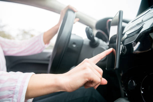 istock Close-up on a woman using GPS on her cell phone while driving her car 1255226950