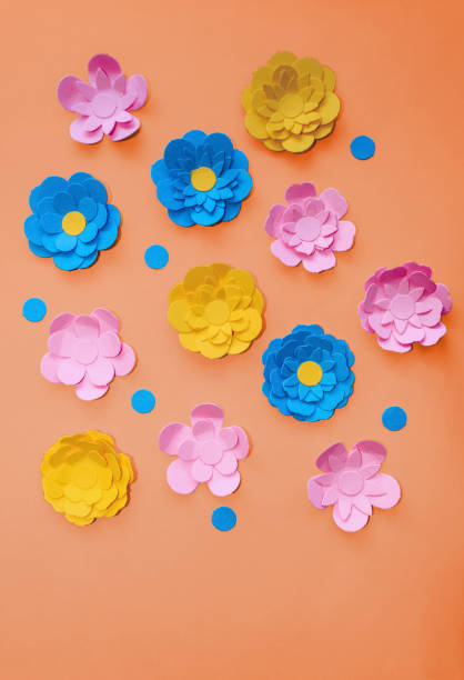 istock cute handmade paper flowers on orange background with space for text 1255229505