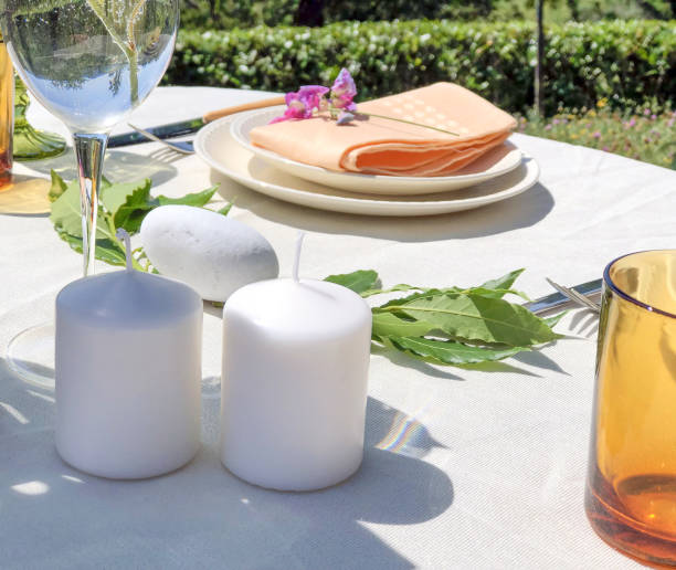 istock Served festive table. Wedding serving. White tablecloth with plates and decor in garden. Wedding concept 1255229892
