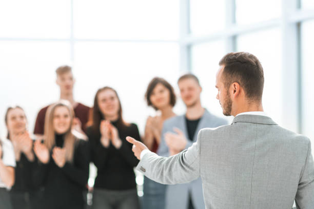 istock blurred image of a group of young people applauding their speak 1255230817