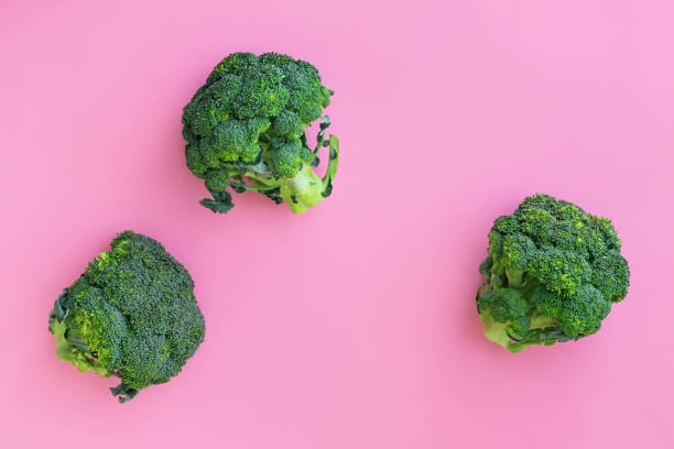 istock Fresh green broccoli on pink background 1255231174