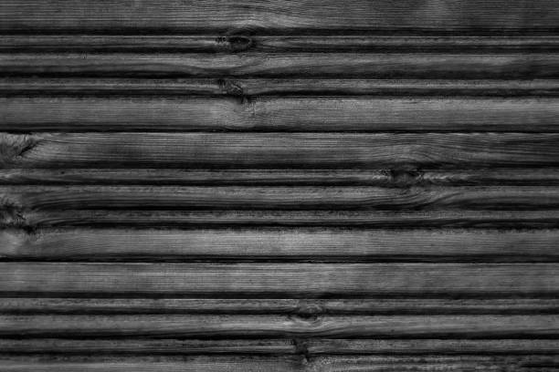 istock Dark wooden textured background. View from front. Copy space. Black and white shot. 1255231958