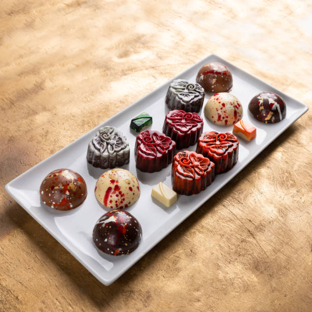 istock Chocolate pieces on the golden background 1255232066