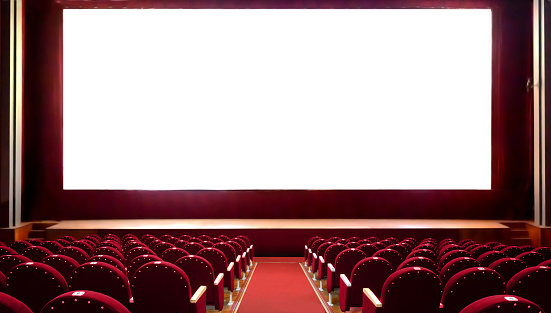 Empty red cinema seats with blank white screen for adding a picture. Empty cinema auditorium.