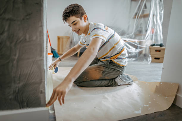 istock Boy preparing on repainting a wall in his room 1255232240