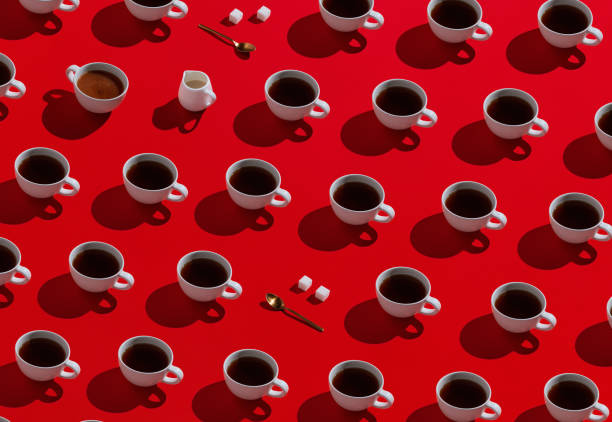 istock Pattern of cups of coffee on red 1255233867