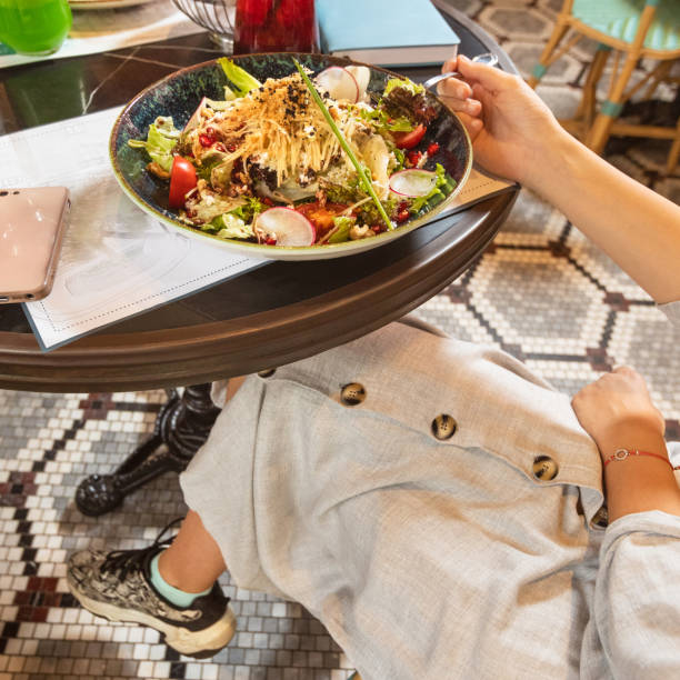 istock Woman eating salad 1255235099