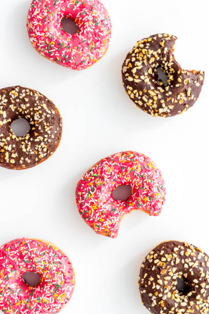 istock Colorful donuts pattern top view. Strawberry and chocolate donuts 1255236050