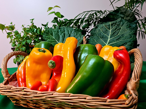 Beautiful and different colorful and healthy peppers exposed in a beautiful basket.