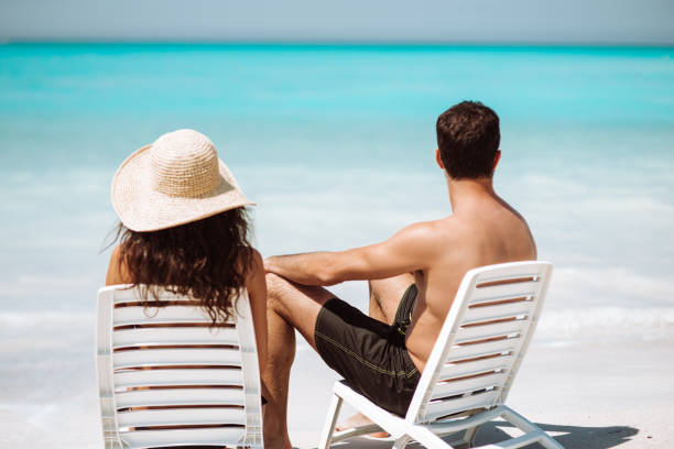 istock couple sitting on the sunbed at the seaside 1255238453