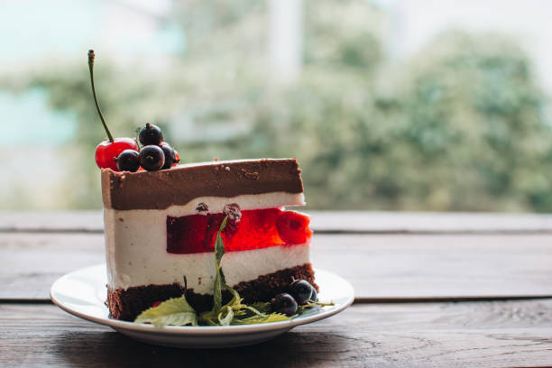 istock Mousse cake with berries on a wooden table. Chocolate cream cake with currants and cherries. Berry cake for birthday, wedding and other holidays. 1255238636