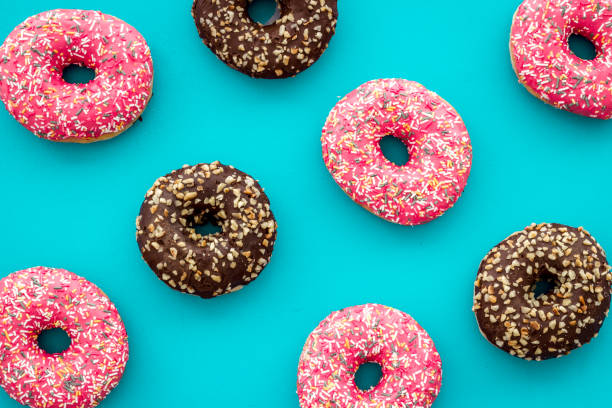 istock Colorful donuts pattern top view. Strawberry and chocolate donuts 1255239436