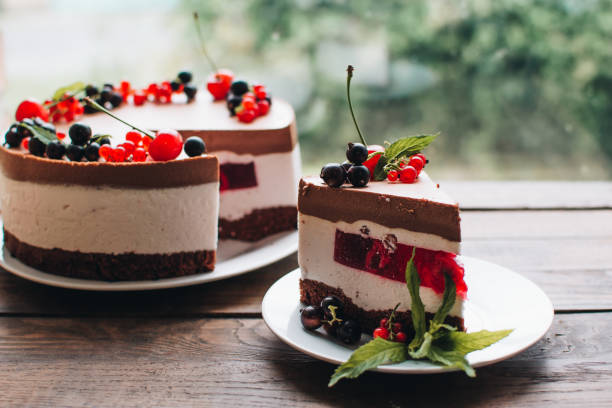 istock Mousse cake with berries on a wooden table. Chocolate cream cake with currants and cherries. Berry cake for birthday, wedding and other holidays. 1255239778
