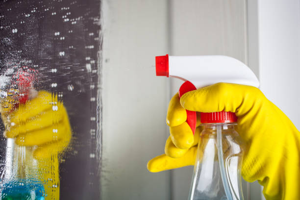 istock Maid with rubber glove cleaning tap and sink. 1255243000