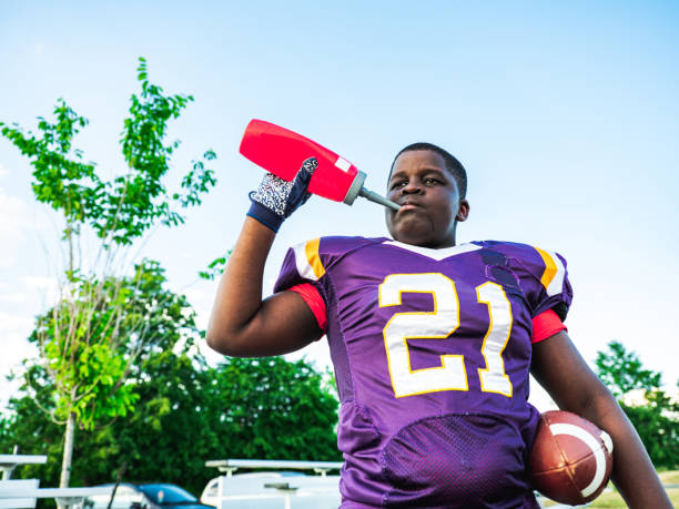 Football. Sport epic action of a male american football players running with the ball. American football player in action and motion. Sport. Running athlete